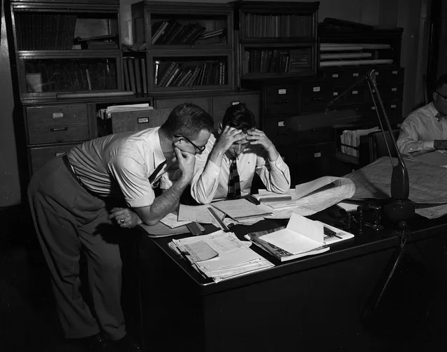Seattle Water Department employees Joiner and Herold at desk, 1956. Why this finance-content release process was put on hold